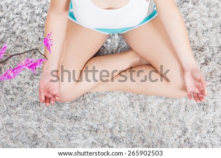 Yoga Meditation Woman Relaxing at home.Healthy Lifestyle in Lotus Posture .Caucasian female meditate on the floor.View from above.