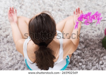 Yoga Meditation Woman Relaxing at home.Healthy Lifestyle in Lotus Posture .Unrecognizable caucasian female meditate  on the floor. View from above.