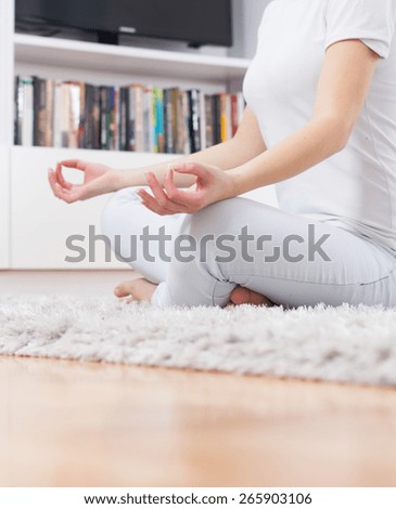 Yoga Meditation Woman Relaxing at home.Healthy Lifestyle in Lotus Posture .Unrecognizable caucasian female meditate  on the floor.