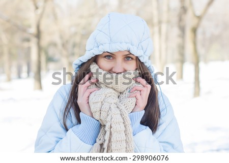 Winter Portrait of Young Woman wearing clothing for cold weather at snow day. Happy Caucasian female wintertime season outdoor.