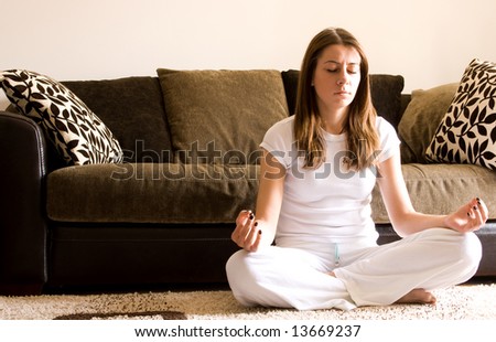 Young woman practice yoga in apartment on floor.