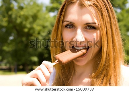 Beautiful young woman eat ice cream.