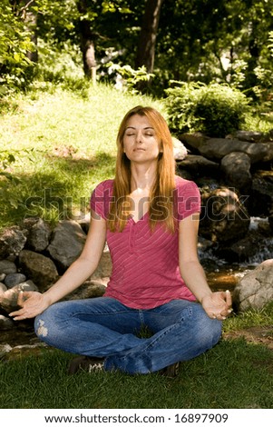 Beautiful young woman practice yoga outdoor.