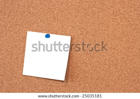 Note pad on cork board table.