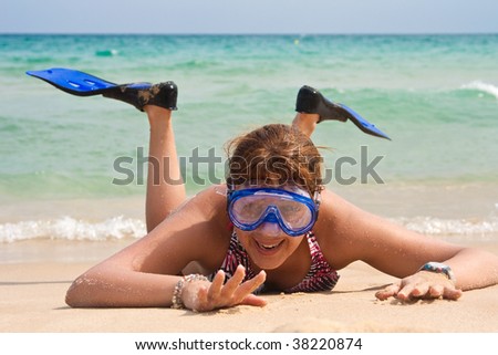Woman with diving mask and flipper fun on the beach.