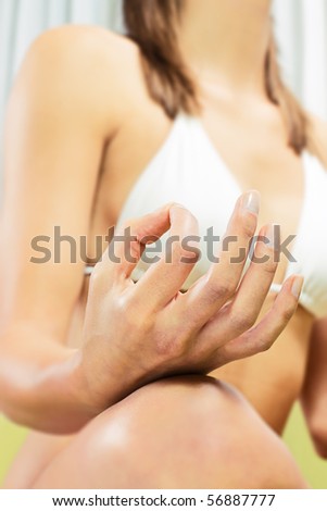 Closeup of woman hands in yoga meditation pose.
