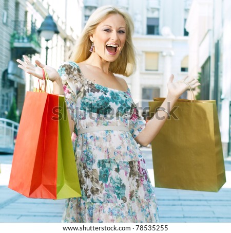 Excited shopping woman with bags.