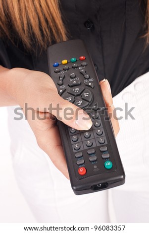 Closeup of remote control in woman hands.