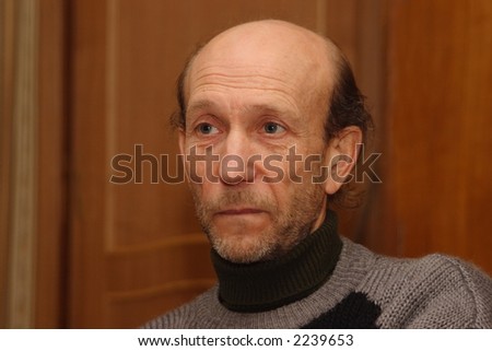 Face of elderly man in grey jacket