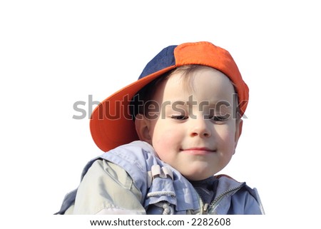 Little boy in orange sideward turned cap looking down,  isolated on white background