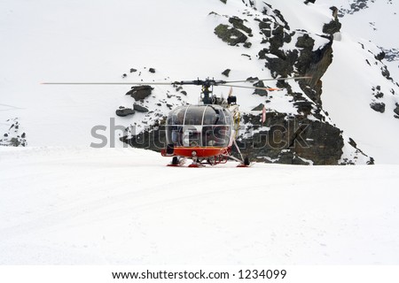 Rescue helicopter flying in snow-storm (Swiss rescue team in the alps)