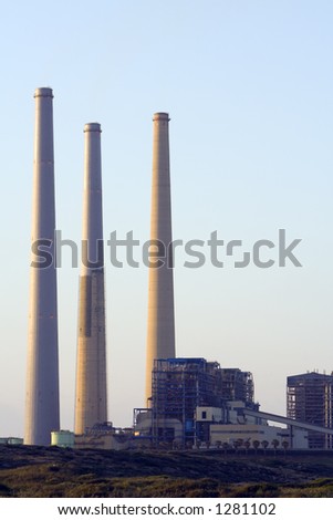 Three Chimneys and big factory in sunset light