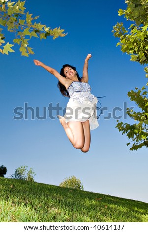 young girl happy jumping at the park