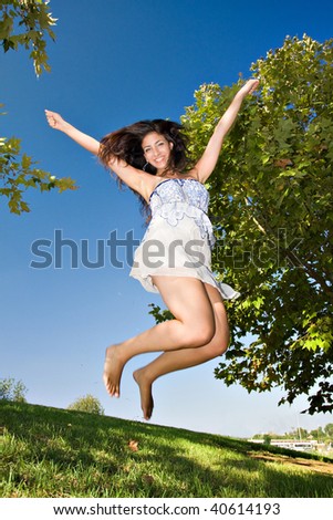 young girl happy jumping at the park