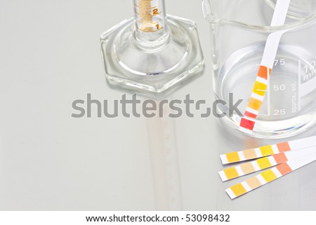 Empty lab chemical containers with PH indicator