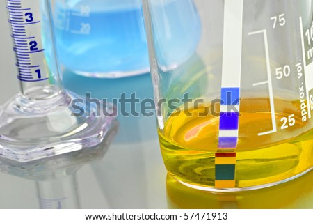 Chemicals in lab glassware with PH indicator