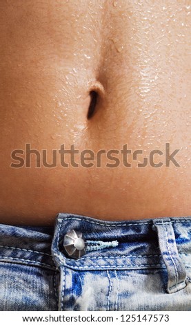 Closeup photo of wet and sexy belly of young girl