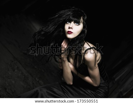 Portrait of a beautiful goth girl among the dark