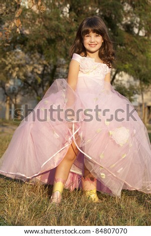 small cute princess in pink dress ans boots