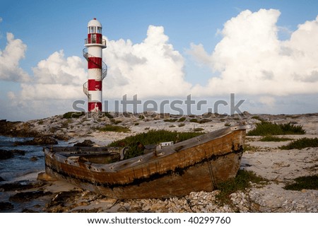 Lighthouse and rusty boat in Punta Cancun Mexico