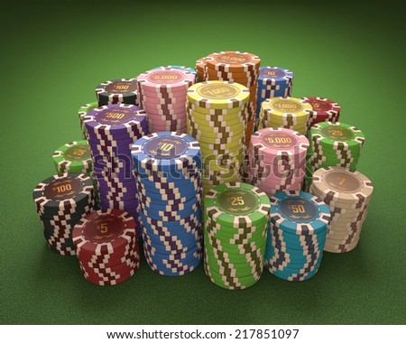 Colorful chips on a green table. Concept of casino and gambling. Clipping path on the chips.