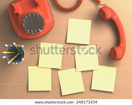 Phone off the hook with sticky notes on the table. Clipping path included on the blank notes.