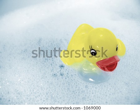 Yellow rubber ducky floating in bubbly water. Black and white image colorized in Photoshop CS.