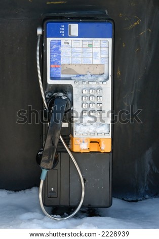 Payphone in winter, partially snow-covered.