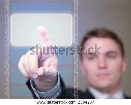 Young businessman pushing a brightly glowing area on a translucent, hi-tech screen. Shallow DOF.