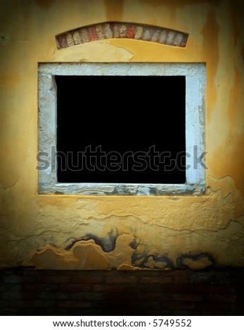 Window in weathered yellow plaster wall with red brick along the bottom in Venice, Italy. Dark window area is suitable for inserting text or image. Image has added film grain effect