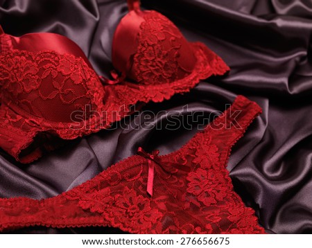 Dark red lacy lingerie womens underwear on black background