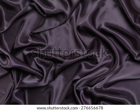 Black shiny silky fabric abstract background texture