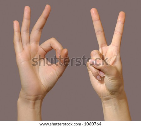 Female hands showing okay and victory gestures