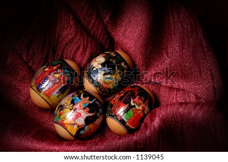 Easter eggs with colorful patterns Light-painted still life over dark red background
