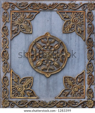 Cast iron metal plate with bronze pattern frame background