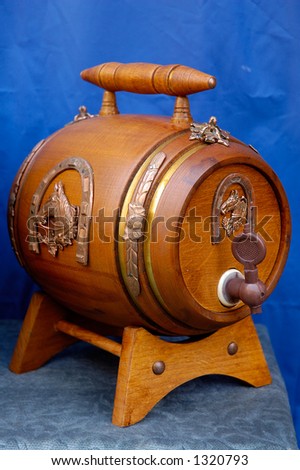 Antique wooden small draught beer keg retro object on blue background