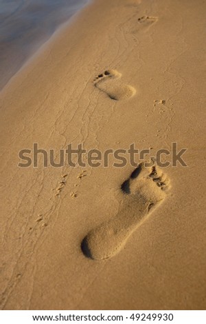 Human footprints on sand. Walk along the beach conceptual photo
