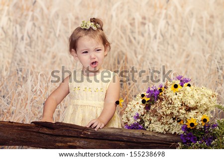 Cute toddler making a very sour face expression for her outdoor portraits