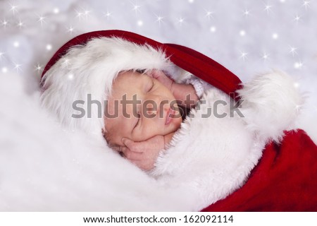 Beautiful sleeping baby boy dressed up as Santa Claus.