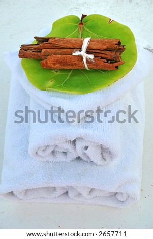 Spa setting with towels and aroma therapy.