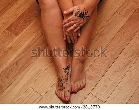 stock photo Womans sexy legs with henna tattoo