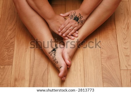 A woman showing off her sexy legs with henna tattoo\'s on them.