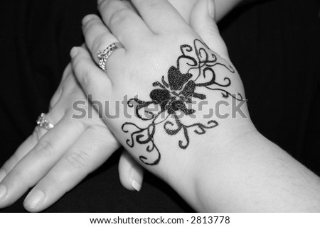A woman\'s hands with a beautiful henna tattoo.