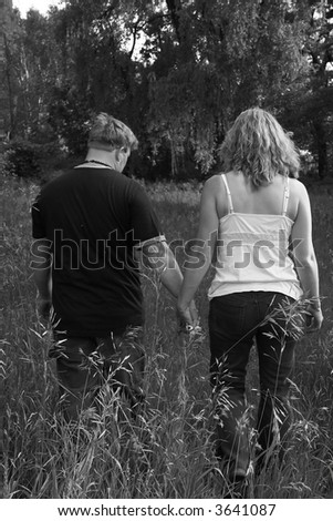 Two people in love taking a walk hand in hand.