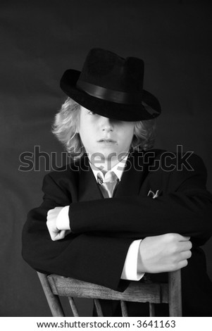 Cool kid looking like a gangster with cool hat