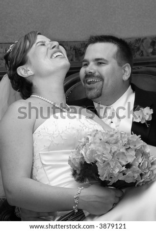 happily married couple laughing together.