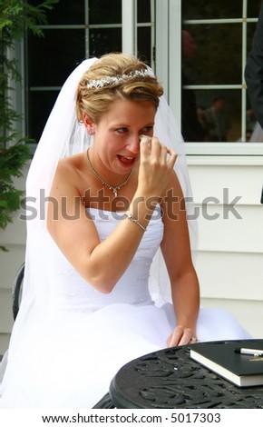 beautiful bride crying during the ceremony