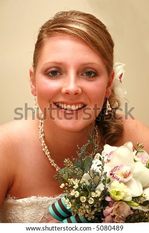 Beautiful young bride with a orchid in her hair