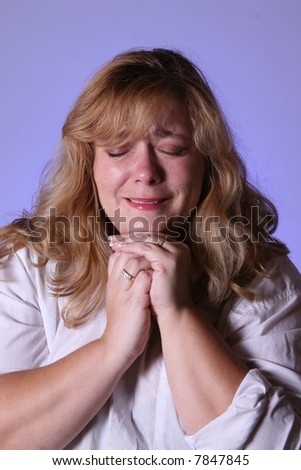 Upset woman crying and praying