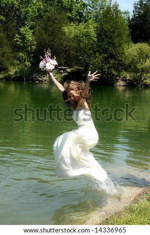 Trash the dress, bride jumping into the water with her dress.
